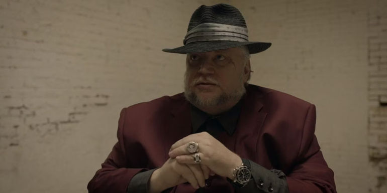 El Toro (Guillermo del Toro) sitting down and looking at someone in Barry season 4 episode 3. - The Chechens Hire Two Podcasters For A Hit On A Special Ops Soldier - Hank And Cristobal Hire Assassins To Kill Barry After They Learn He's An Informant