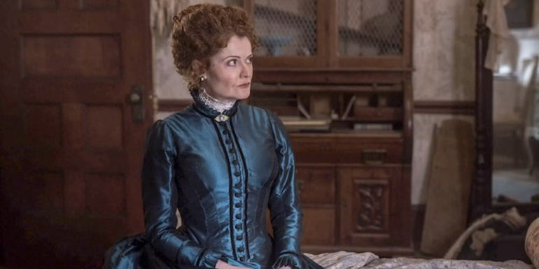 Hetty sitting on a bed in Ghosts - Season 3 might finally show it. - Ghosts Still Hasn't Revealed How Hetty Died