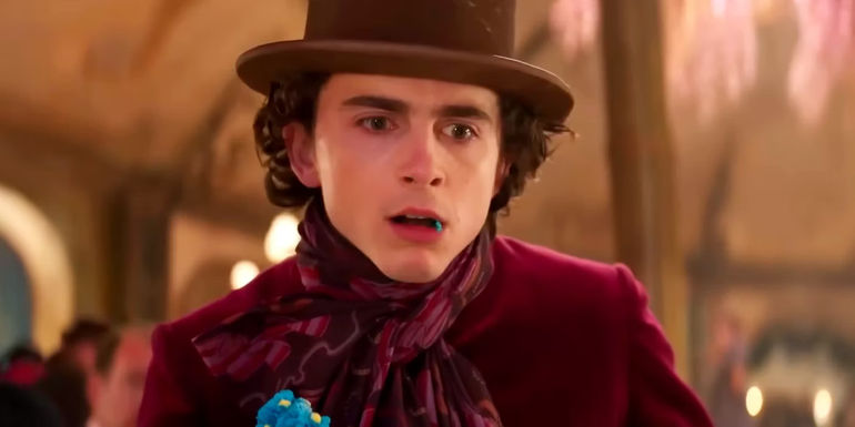Timothee Chalamet as Willy Looking Shocked with Candy in His Mouth in Wonka