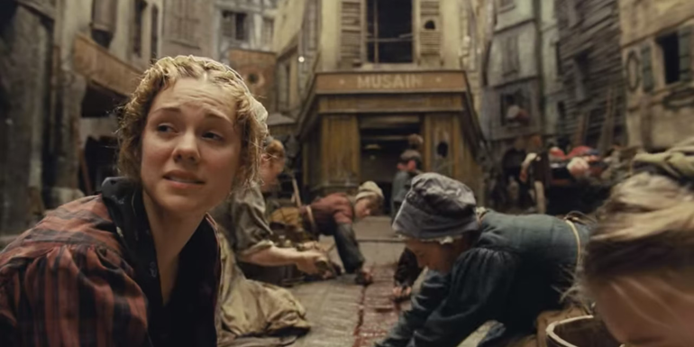 Women scrubbing blood from the cobblestones after the battle in Les Miserables