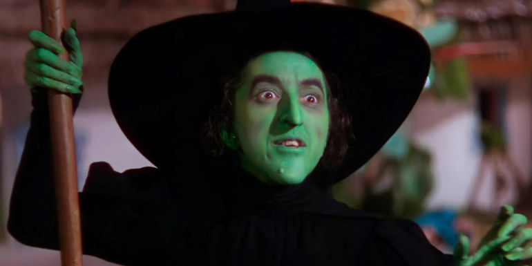The Wicked Witch of the West (Margaret Hamilton) holds her broomstick in The Wizard of Oz (1939).