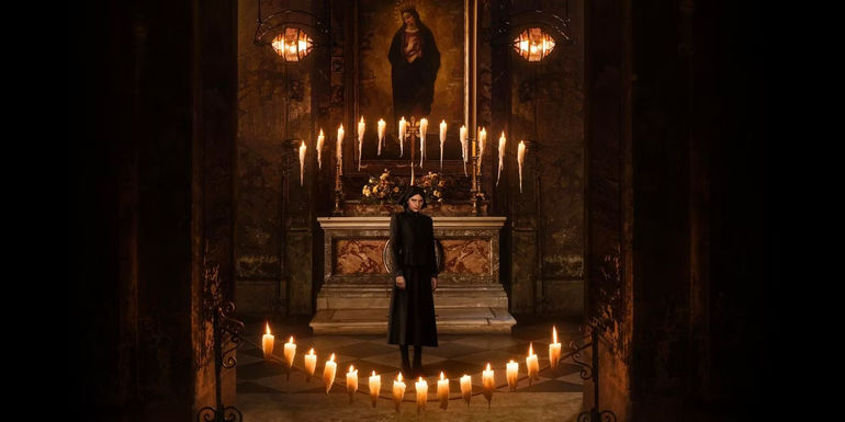 Nell Tiger Free standing among candles in a church in The First Omen's trailer