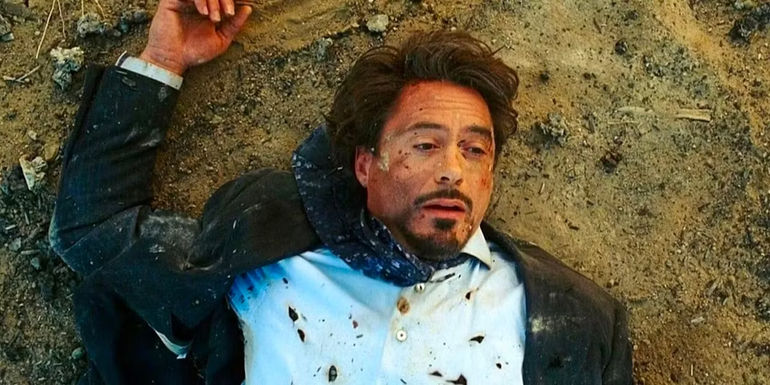 Robert Downey Jr. as Iron Man/Tony Stark lying on the ground after the explosion in Iron Man