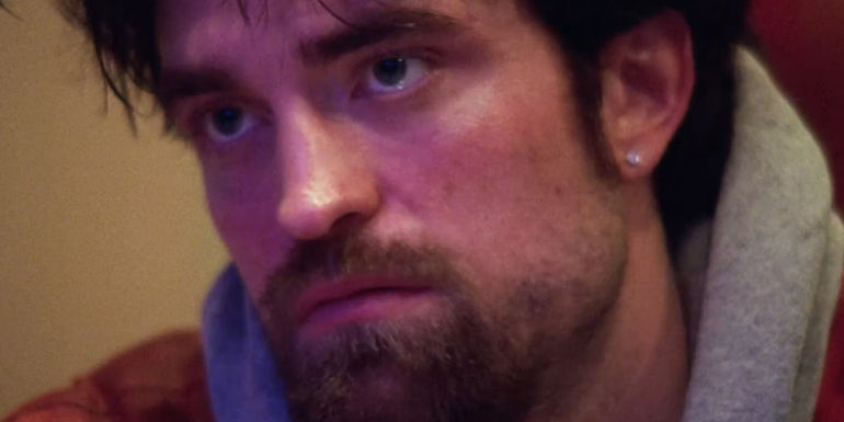 Robert Pattinson looking at something in Good Time