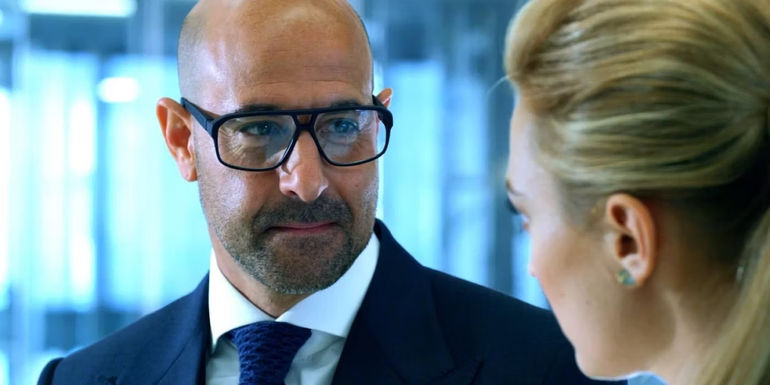 Tucci's Joshua Joyce standing across assistant in Age of Extinction