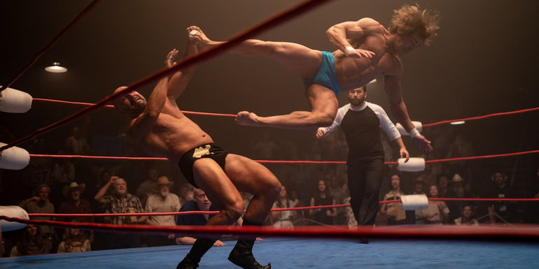 Zac Efron as Kevin Von Erich performing a flying kick in The Iron Claw.