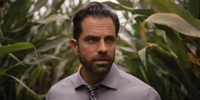Gerardo Celasco as Detective Lopez looking concerned in a cornfield in Devil in Ohio.