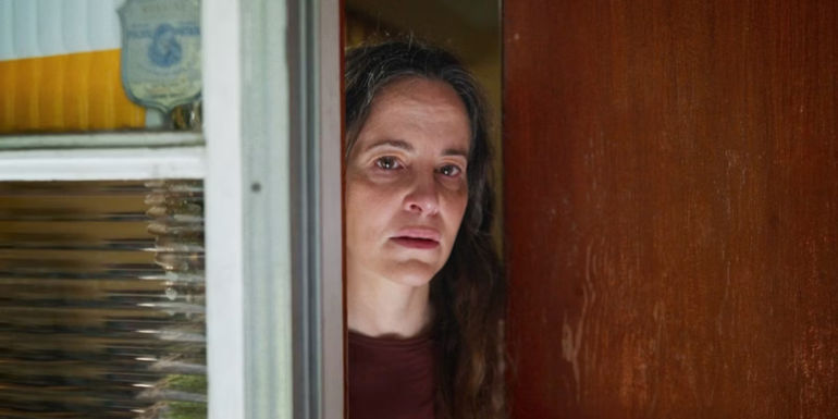 Maria Dizzia as Ms. Nears behind a door in School Spirits