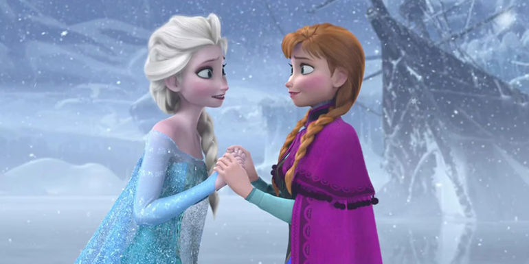 Elsa and Anna look at each other while holding hands in Frozen.