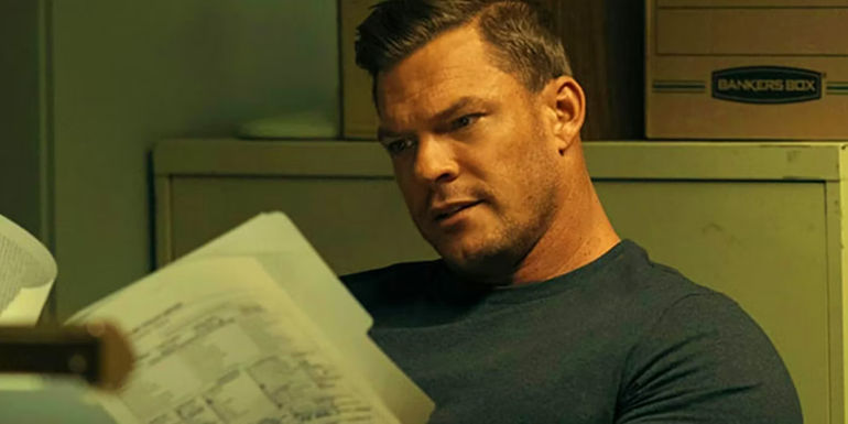 Alan Ritchson's Jack Reacher reading a document in Reacher