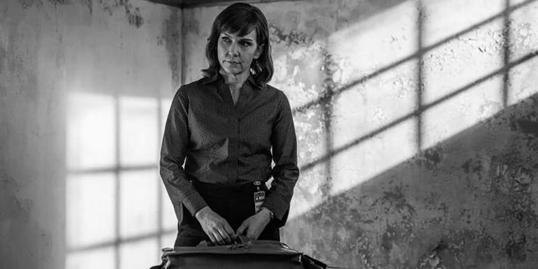 Kim with her briefcase in the prison meeting room in a black and white scene from Better Call Saul.