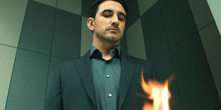 Ferdinand Kingsley as A.M. burning a passport in Reacher season 2