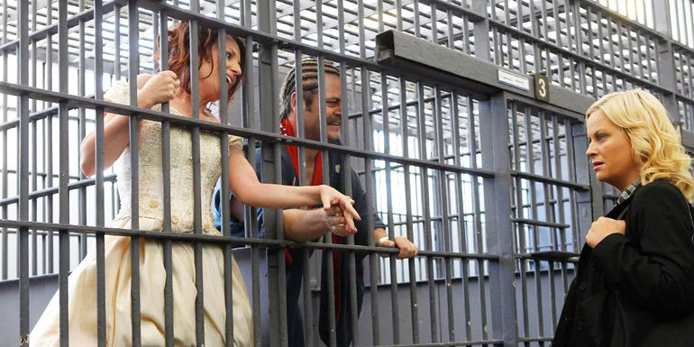 Megan Mullally as Tammy 2 and Nick Offerman as Ron in a jail cell after getting married again in Parks and Recreation