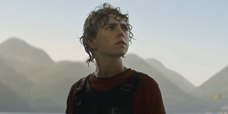 Walker Scobell as Percy Jackson, with wet hair, is looking up in Percy Jackson and the Olympians.
