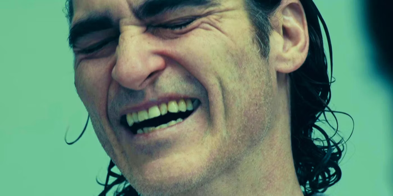 Joaquin Phoenix as Arthur Fleck laughing in Joker