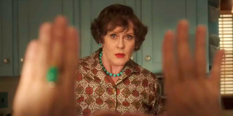 Sarah Lancashire as Julia Child with someone framing her with their hands in Julia season 2