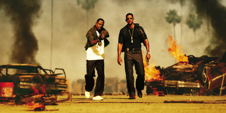Miami police officers Mike Lowrey and Marcus Burnett walk away from the burning wreckage of two cars in Bad Boys 2