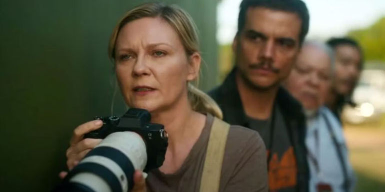 Kirsten Dunst from Civil War holding a camera