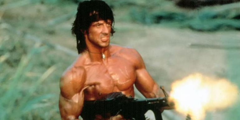 Sylvester Stallone shooting a gun while shirtless in Rambo