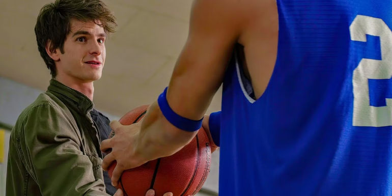 Flash Thompson grabbing a basketball being held by Andrew Garfield's Peter Parker