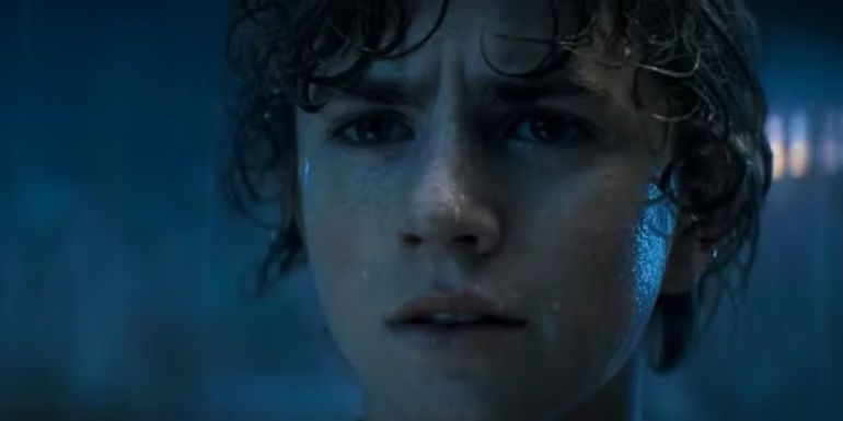 Percy standing in the rain and looking out in Percy Jackson and the Olympians.