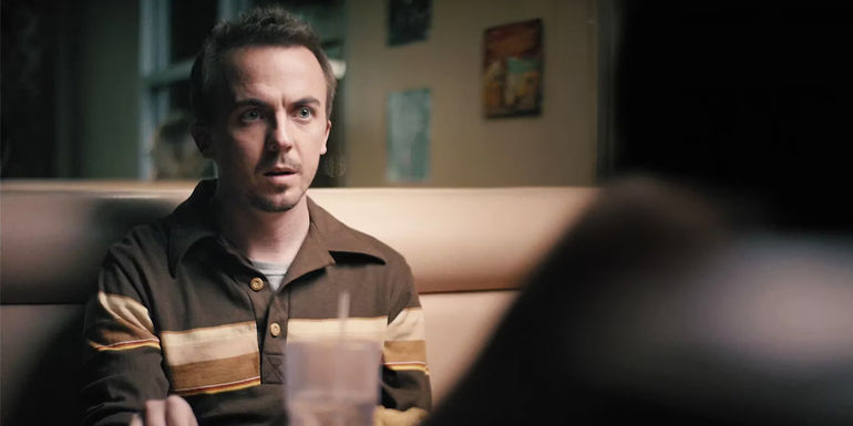 Frankie Muniz sitting at a table in The Black String