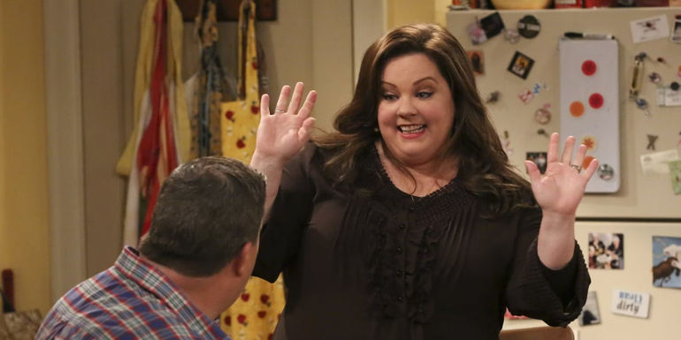 Molly (Melissa McCarthy) holding her hands up to Mike (Billy Gardell) in Mike and Molly