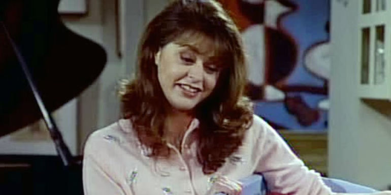 Daphne smiles in Frasier's apartment in Frasier