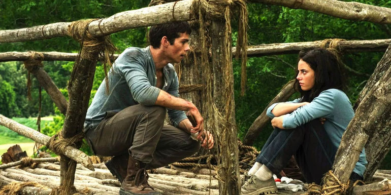 Dylan O'Brien and Kaya Scodelario as Thomas and Teresa talk in the Glade of the Maze in The Maze Runner