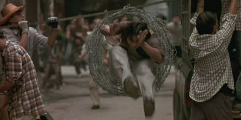 Tony Jaa jumping through a ring of barbed wire during Ong Bak's foot chase
