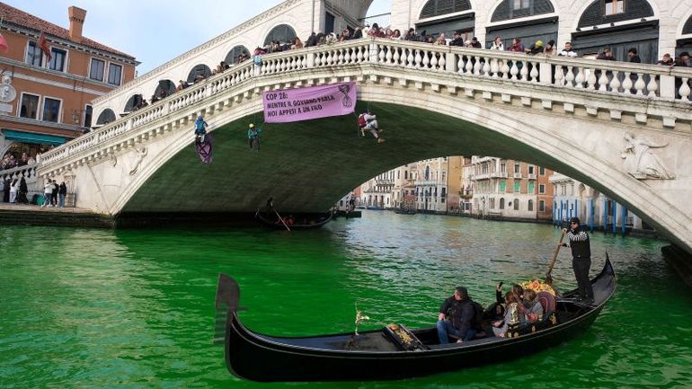 Extinction Rebellion activists turn Venice's Grand Canal green in protest at COP 28