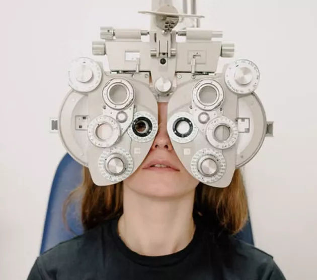 Patient receiving a comprehensive eye exam using a phoropter at Clear Perspective Eyecare in Albuquerque, NM