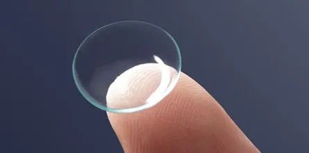 Contact lens resting on a fingertip