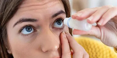 Person applying eye drops for dry eye relief
