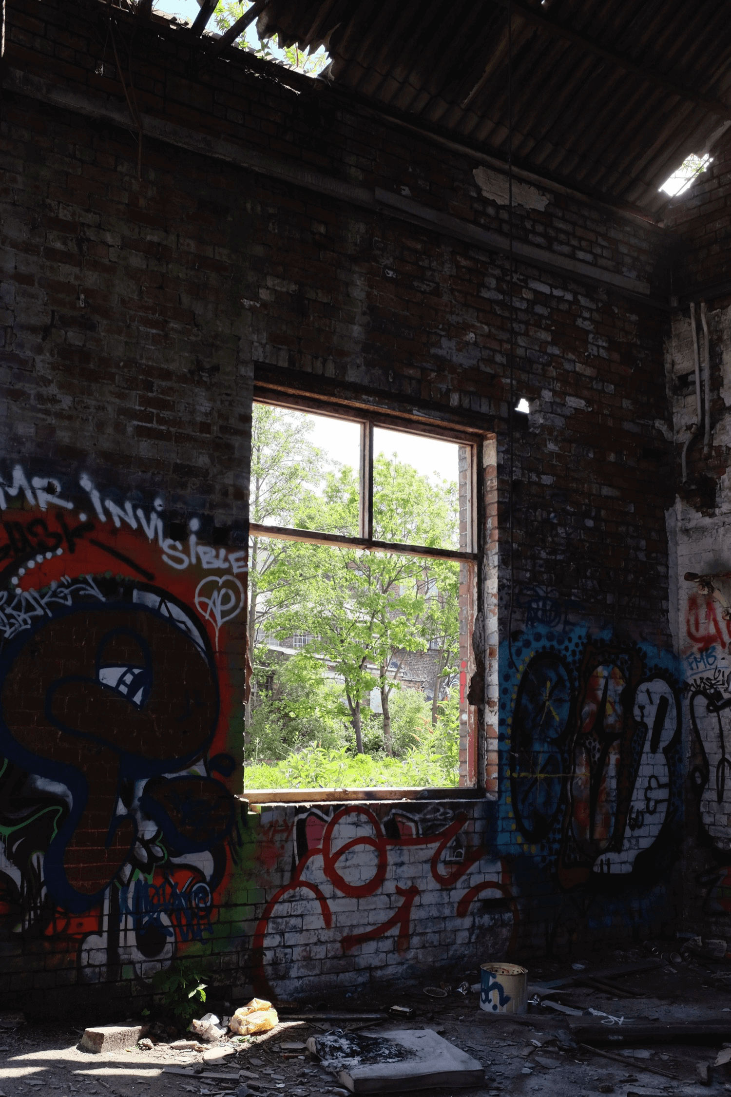 Inside a building with graffiti on the wall