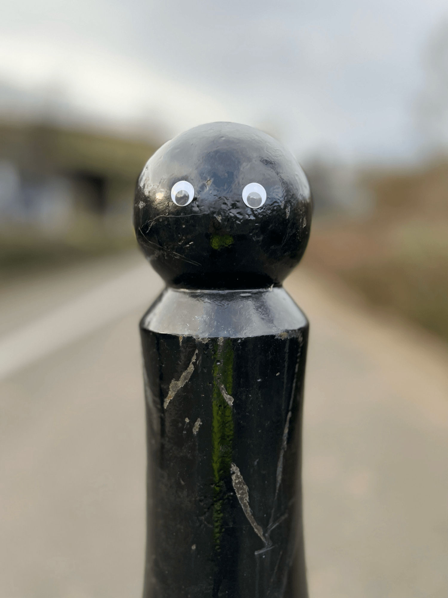 A bollard with stick on eyes