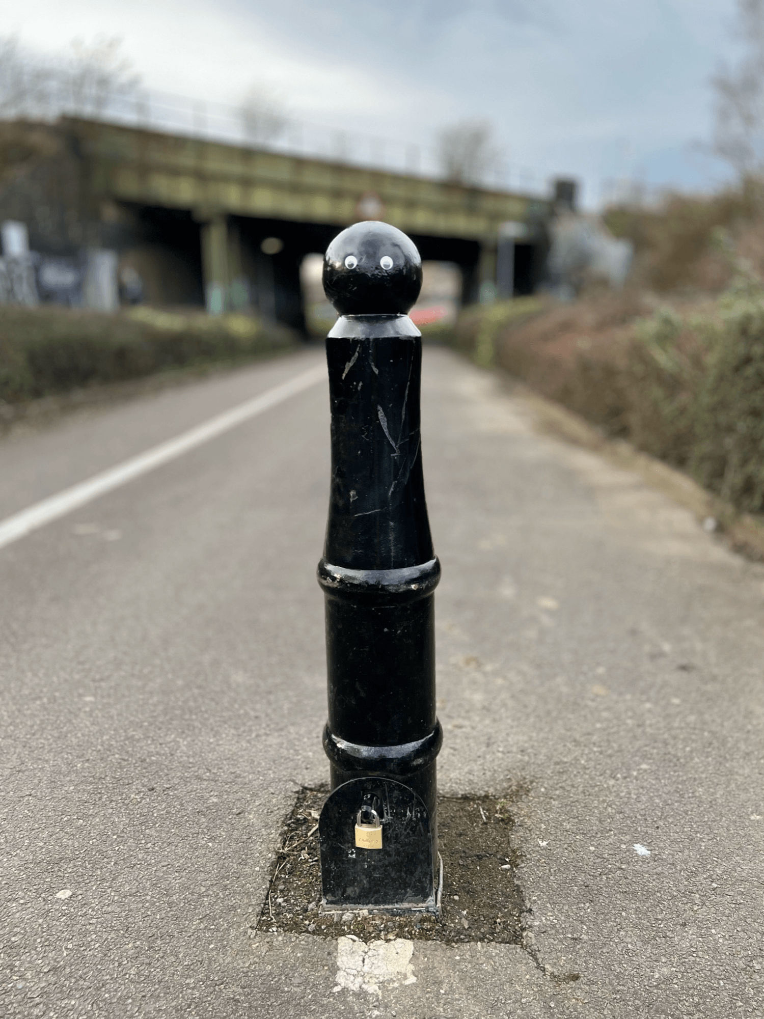 A bollard with stick on eyes