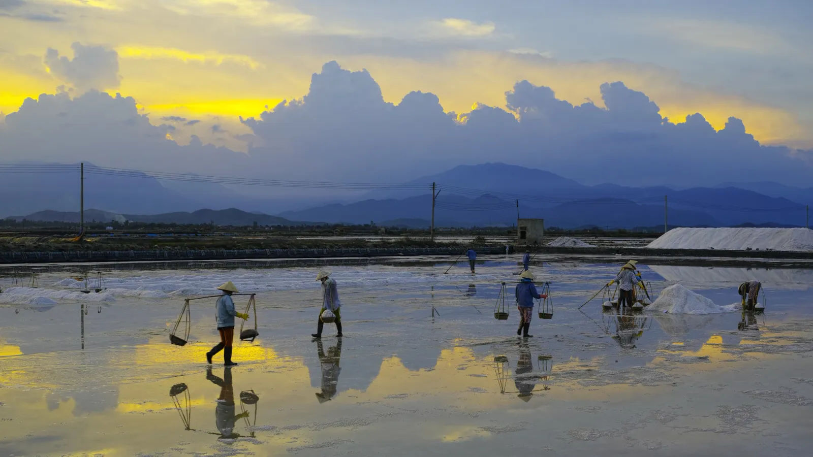 Diêm dân gánh muối trên ruộng muối Ninh Hoà lúc sáng sớm