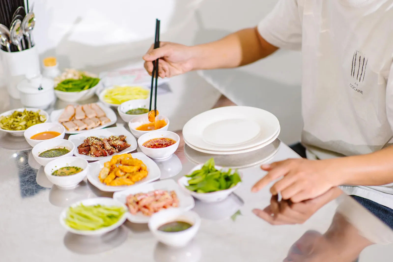 A spread of dipping sauces and grilled meat at the shop. Not bánh đập