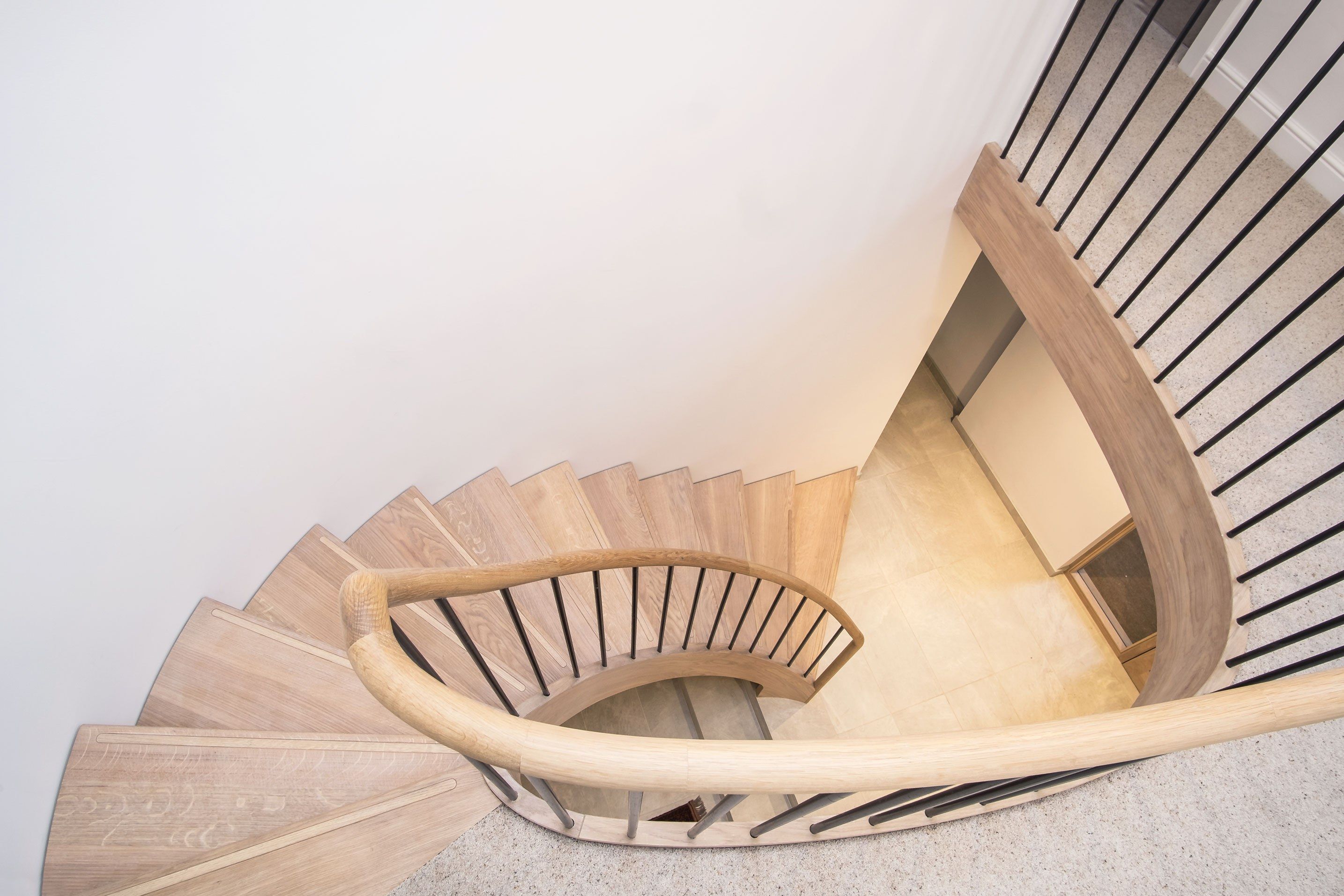 Birds eye view of feature Elliptical oak stair with iron balustrade, curved oak handrail and curved oak bridal.