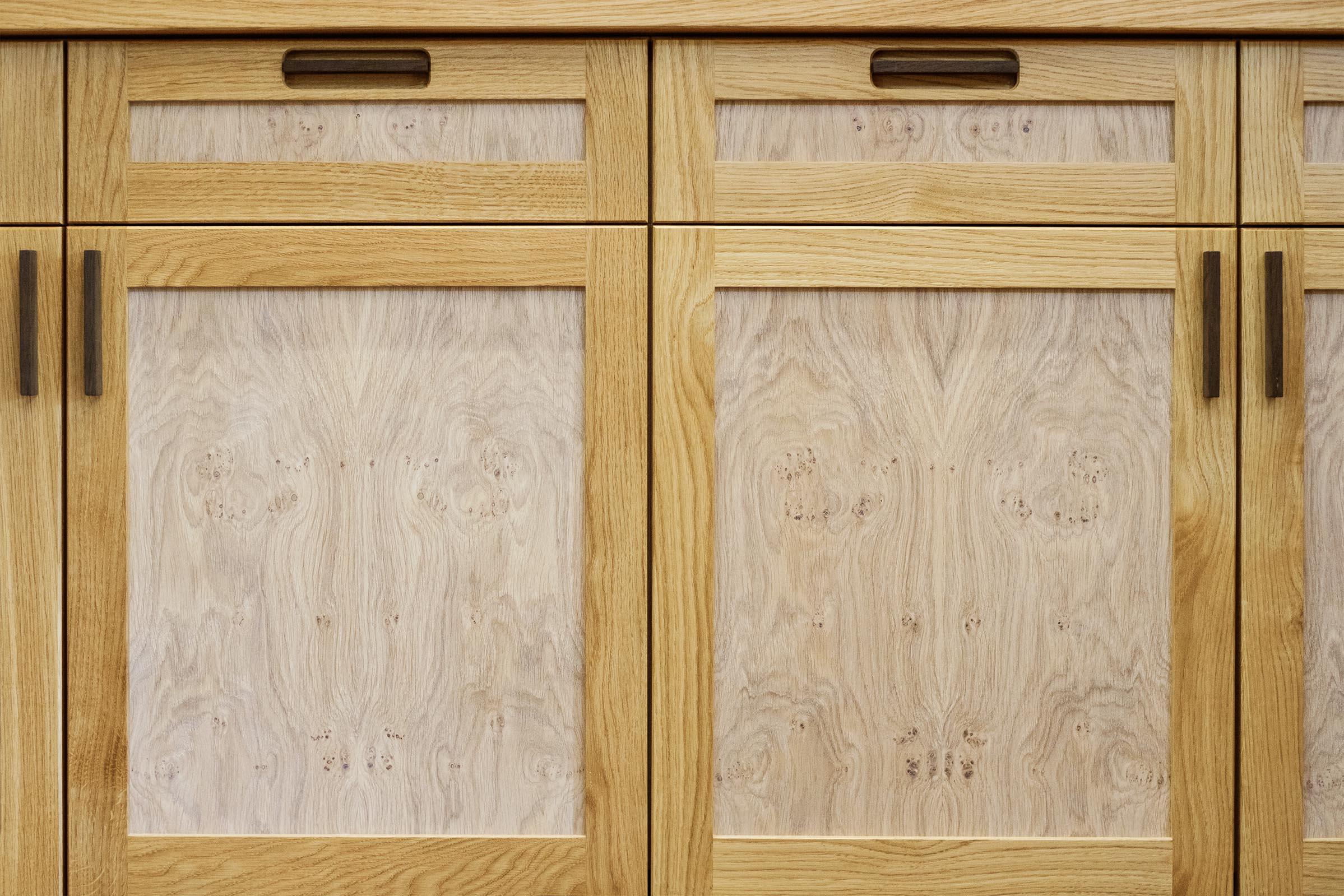 Oak bookcases and cabinets with pippy oak veneered doors.