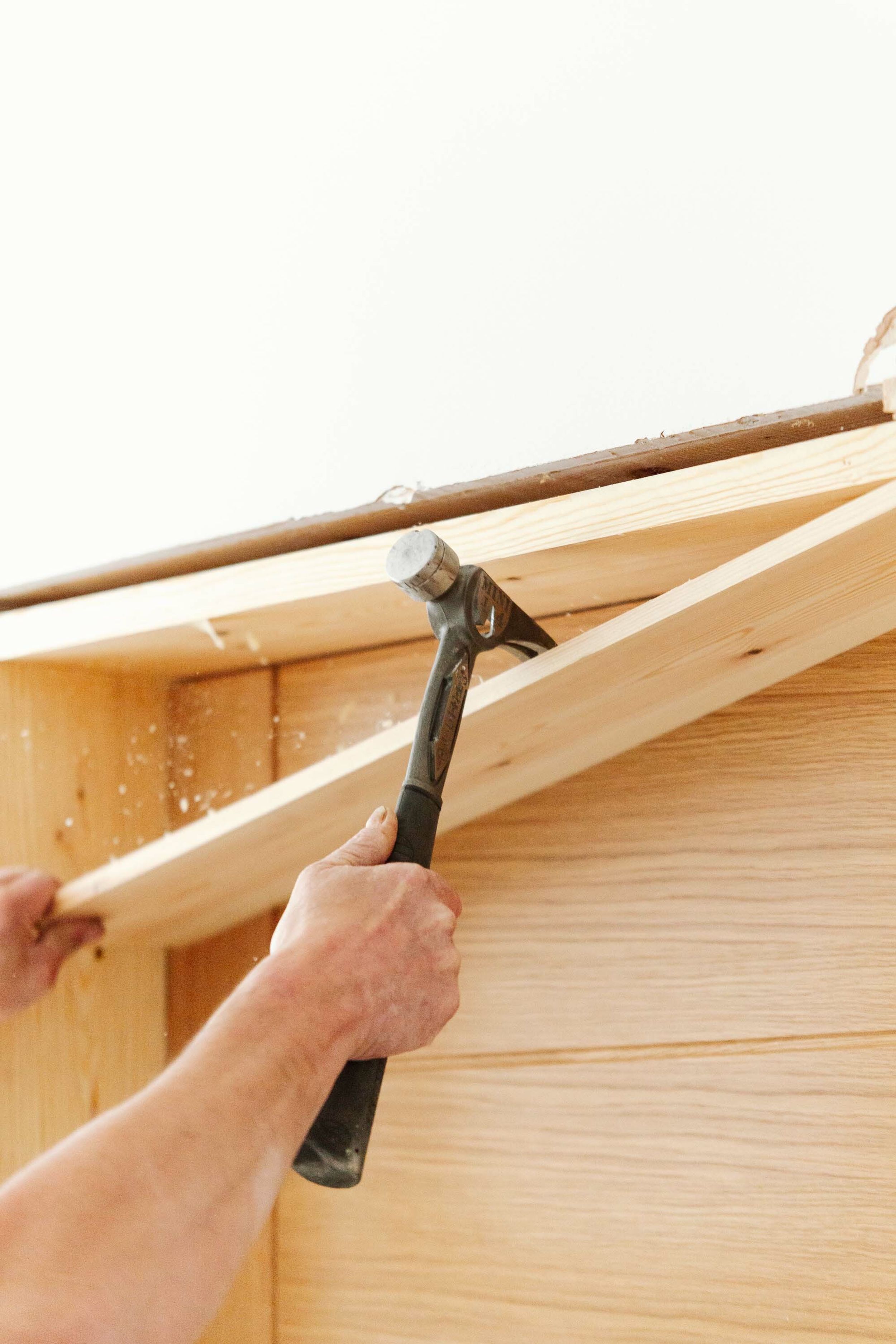 Close up shot of a hammer’s claw pulling and breaking timber.