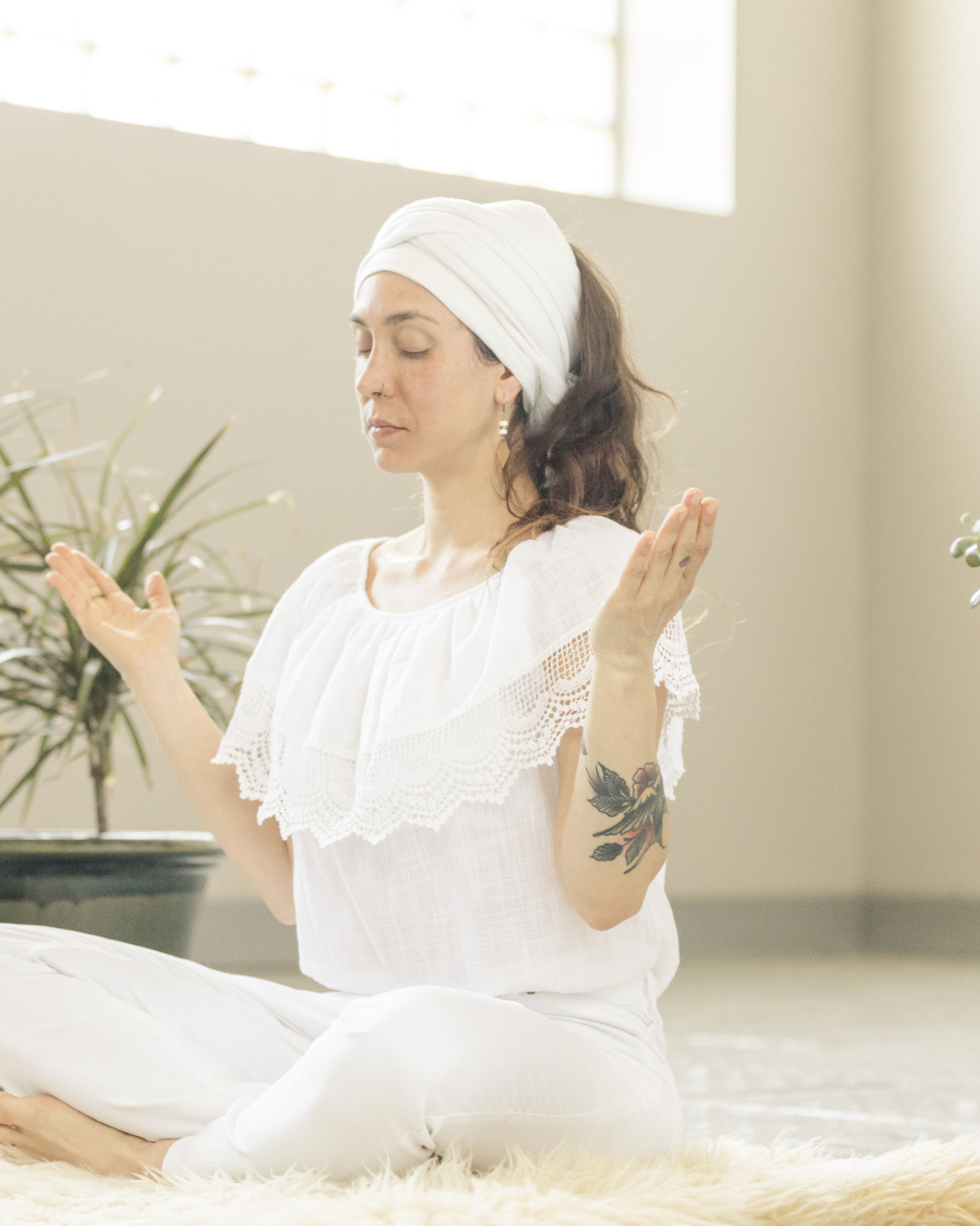 Students in white clothing during a Kundalini Yoga class