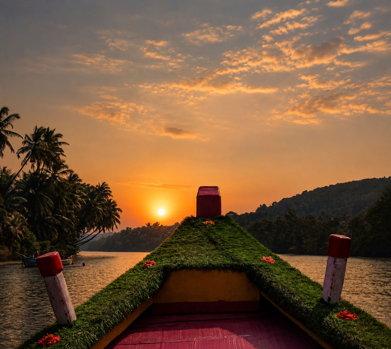 Sunset over the Sharavathi river seen from a decorated boat on the Honnavar backwaters