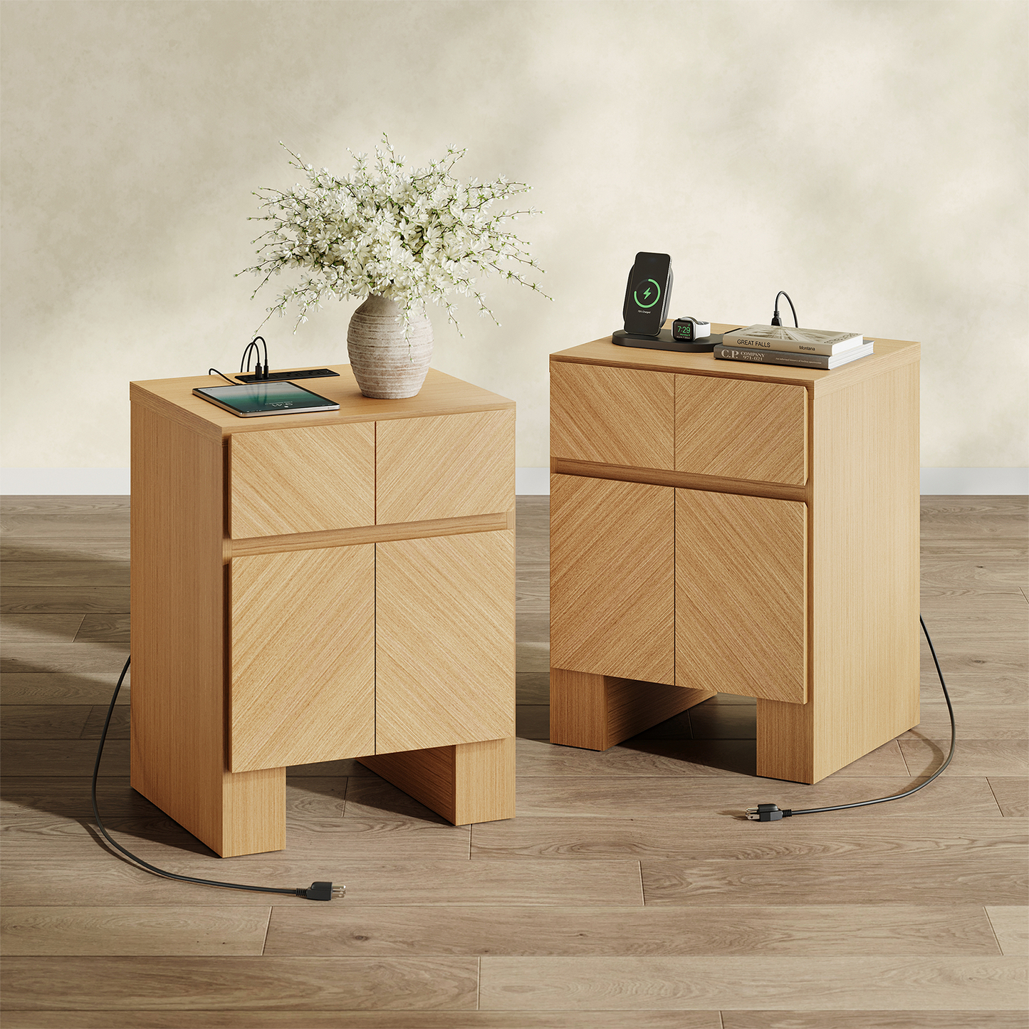 Two light wood cabinets have four handleless panels, open bases, and top-mounted power strips with connected devices