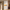 Tall white cabinet has four fluted doors and a lit open center niche