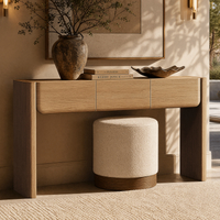 Wood-toned console table and stool in a furnished room