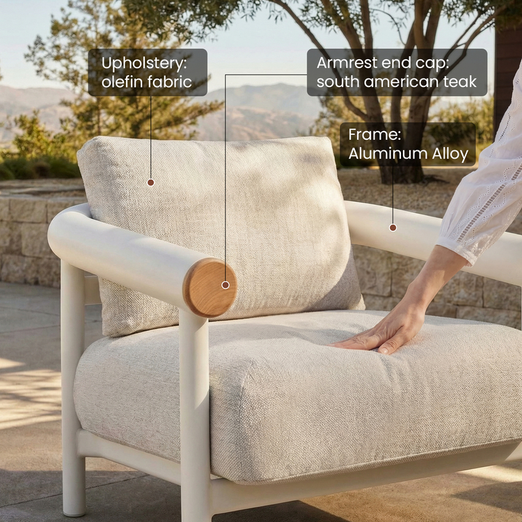 A hand presses the seat cushion, Rounded end caps finish the armrests