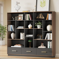 A charcoal cubby bookcase with brown trim stands against a wall, Three bottom drawers have slim gold-colored handles