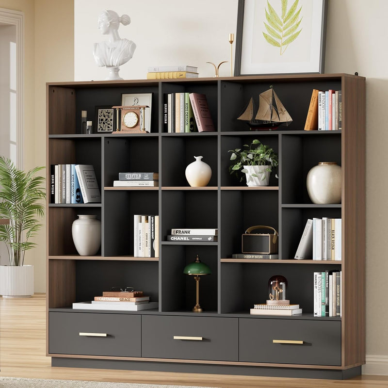 A charcoal cubby bookcase with brown trim stands against a wall, Three bottom drawers have slim gold-colored handles